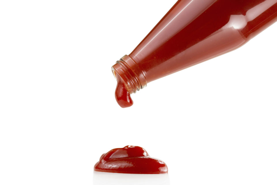 Tomato ketchup falling from bottle